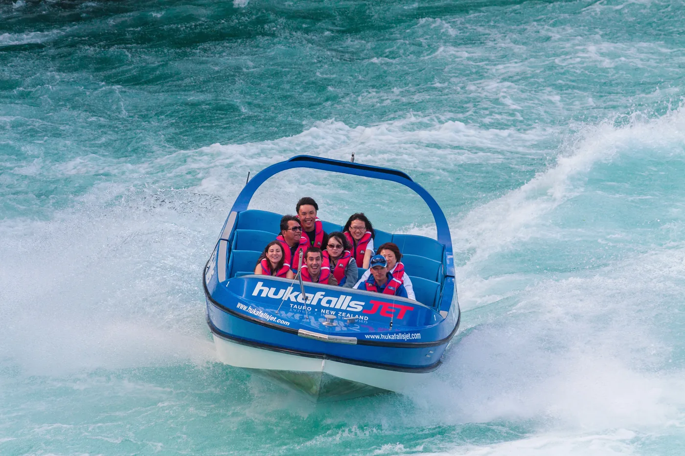 A jet boat carrying adventure-tour customers through white water